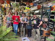 Terrarium workshop attendees holding finished glass terrariums at Newtown Garden Market King Street